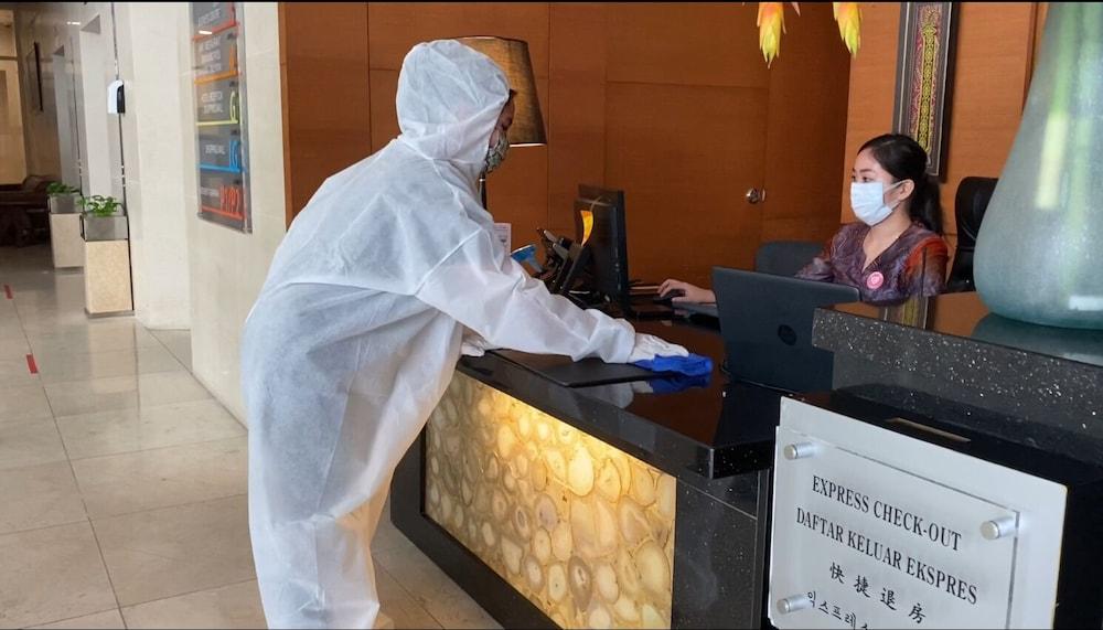 The Waterfront Hotel Kuching Dış mekan fotoğraf A guest wearing a hazmat suit at a hotel in Beijing, China